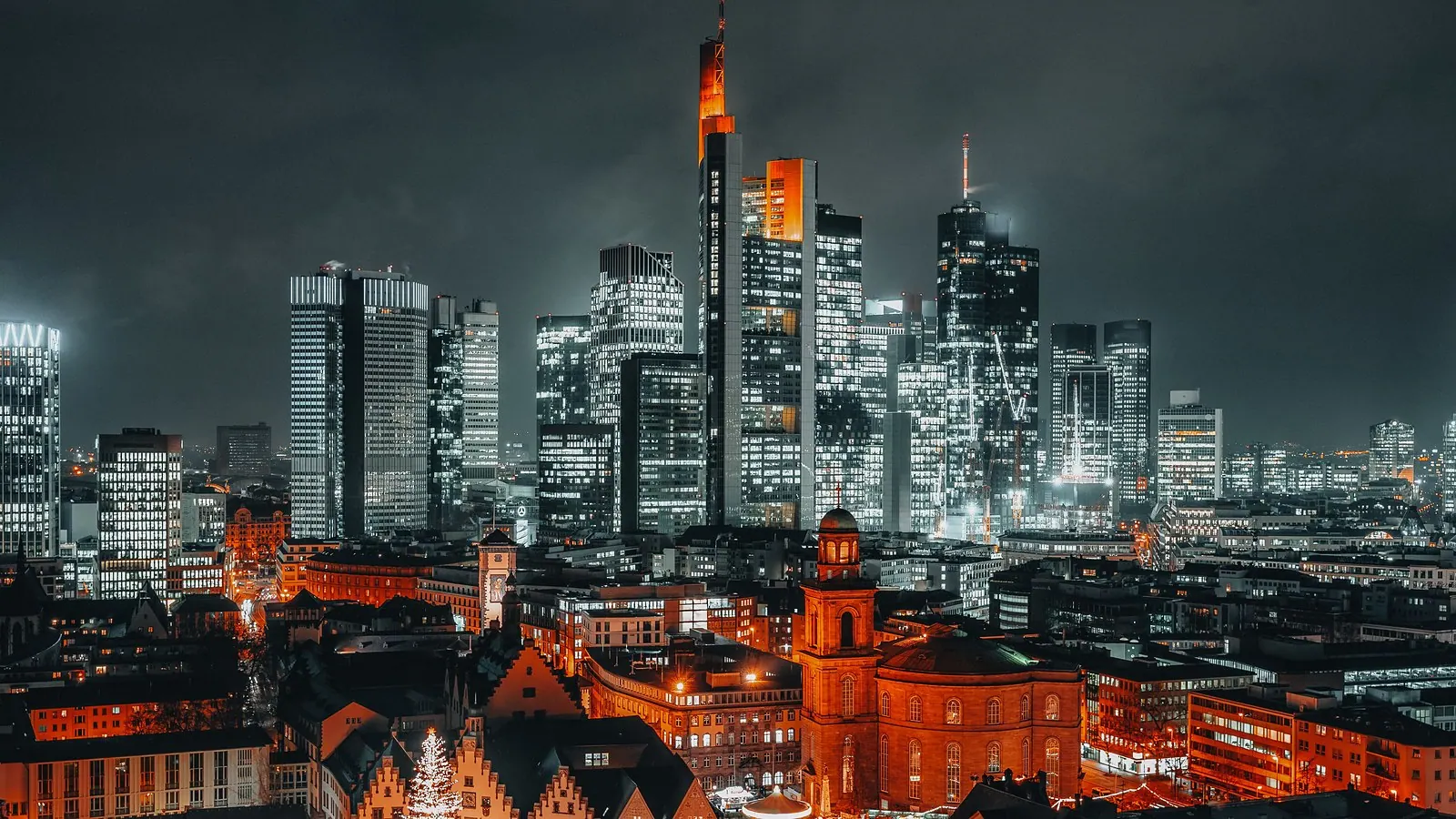 Frankfurt financial district at night with the lit old town below