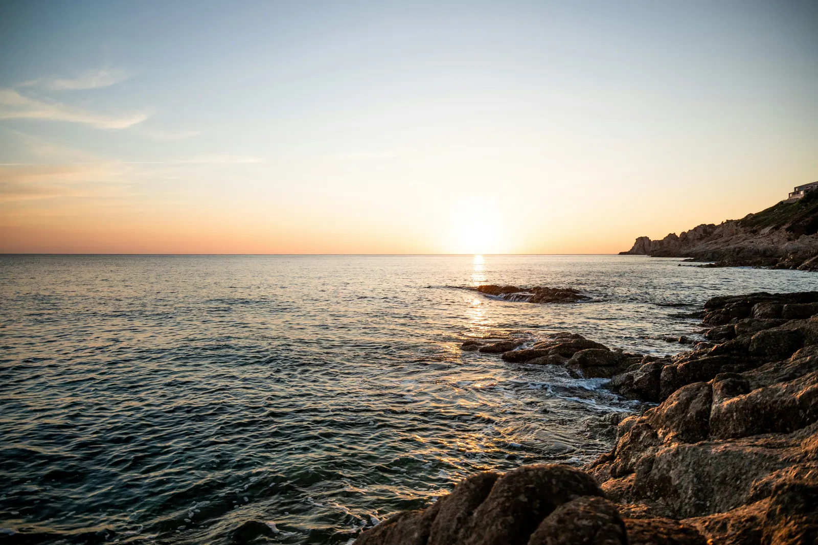 Calm Mediterranean coastline at sunset